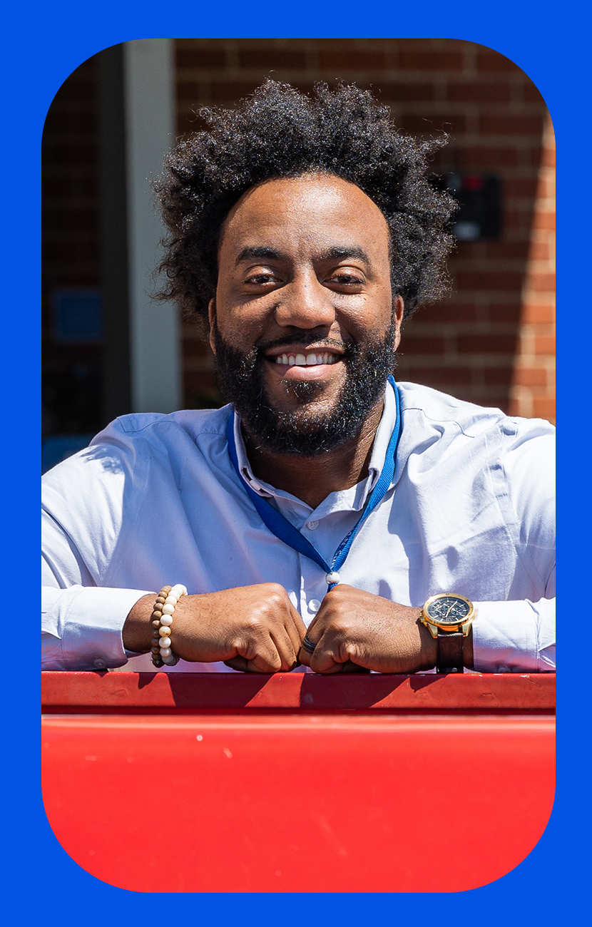 Market People Partner Anthony Agnew smiling in the sun with the  Walmart Home Office behind him.